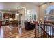 Bright and airy living room with hardwood floors, large windows, and open access to the kitchen at 5055 Mcclure Ln, Castle Rock, CO 80108