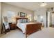 A bright main bedroom with a dark wood sleigh bed and ample natural light at 5055 Mcclure Ln, Castle Rock, CO 80108