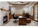 Cozy office with a fireplace, built-in bookshelves, wood desk, and ample natural light at 5055 Mcclure Ln, Castle Rock, CO 80108