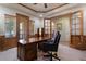 Spacious office with built-in shelving, wood trim, and natural light at 5055 Mcclure Ln, Castle Rock, CO 80108