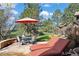 Charming outdoor patio with a dining table, chairs, lounge chairs, and umbrella, creating a perfect space to unwind at 5055 Mcclure Ln, Castle Rock, CO 80108