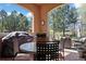 Covered patio featuring a grill, dining table, and comfortable seating, ideal for outdoor dining and entertaining at 5055 Mcclure Ln, Castle Rock, CO 80108