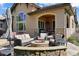 Inviting patio with a stone fireplace, comfortable seating, and an umbrella, perfect for outdoor gatherings and relaxation at 5055 Mcclure Ln, Castle Rock, CO 80108