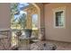 Outdoor patio with stone pillars, wrought iron furniture, and a serene view at 5055 Mcclure Ln, Castle Rock, CO 80108