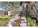 Well-manicured yard features stream, stones, landscaping, and view of home at 5055 Mcclure Ln, Castle Rock, CO 80108