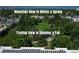 Stunning aerial view of the community with lush treetop views and picturesque mountain backdrop at 2240 N Clay St # 406, Denver, CO 80211
