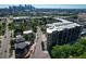An aerial view showcases Denver city skyline near the condo with solar panels and lush green trees at 2240 N Clay St # 406, Denver, CO 80211