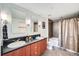 Modern bathroom with double sinks, a dark countertop, and tiled shower-tub combination at 2240 N Clay St # 406, Denver, CO 80211