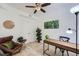 Cozy bedroom featuring neutral carpet, ceiling fan, modern desk and a brown leather chair at 2240 N Clay St # 406, Denver, CO 80211