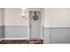 Front entrance of a residence showing grey wainscotting, wreath and “sweet home” welcome mat at 2240 N Clay St # 406, Denver, CO 80211