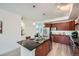 Modern kitchen with stainless steel appliances and a breakfast bar near a dining area at 2240 N Clay St # 406, Denver, CO 80211