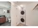Convenient laundry area equipped with a stacked washer and dryer, plus a utility sink at 2240 N Clay St # 406, Denver, CO 80211