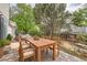 Cozy backyard with a stone patio, wooden dining table, and comfortable outdoor seating area at 3777 S Walden St, Aurora, CO 80013