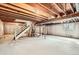 Unfinished basement with exposed beams, and a staircase at 3777 S Walden St, Aurora, CO 80013