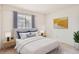 Bedroom featuring a large window with window treatments for natural light at 3777 S Walden St, Aurora, CO 80013