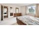 Bedroom with carpet, large bed and natural light with a view of the ensuite bathroom at 3777 S Walden St, Aurora, CO 80013