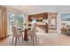 Bright dining area features a modern round table, seating for four, and beautiful natural light at 3777 S Walden St, Aurora, CO 80013