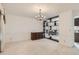 Spacious dining area featuring a vintage chandelier and ample room for entertaining at 3777 S Walden St, Aurora, CO 80013