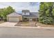 Inviting two-story home with a covered front porch, complemented by lush trees and a convenient two-car garage at 3777 S Walden St, Aurora, CO 80013