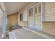 Close-up of the front porch, showcasing the home's secure, decorative screen door and brick accents at 3777 S Walden St, Aurora, CO 80013