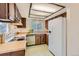 Classic kitchen with wood cabinets, white appliances, and a window overlooking the outdoors at 3777 S Walden St, Aurora, CO 80013