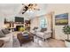 Staged living room featuring a brick fireplace, comfortable seating, and bright, natural light at 3777 S Walden St, Aurora, CO 80013