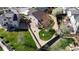 Aerial view of the house showing the backyard, fencing and lawn with a tree and stone landscaping at 6079 W Prentice Ave, Littleton, CO 80123