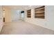 Basement featuring neutral colored carpet and recessed shelves for decorative accents or storage at 6079 W Prentice Ave, Littleton, CO 80123