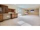 Spacious finished basement with carpet, built-in cabinets, and sliding glass doors to the outside at 6079 W Prentice Ave, Littleton, CO 80123