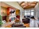 Inviting living room boasts a stone fireplace, wood floors, and lake views at 6079 W Prentice Ave, Littleton, CO 80123