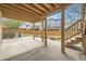 Covered patio with concrete flooring and stairs to the deck, providing shade and outdoor space at 6079 W Prentice Ave, Littleton, CO 80123