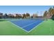 Well-maintained blue and green tennis courts for recreational enjoyment with scenic neighborhood backdrop at 6079 W Prentice Ave, Littleton, CO 80123
