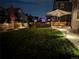 Expansive backyard with patio furniture, string lights, and a lush lawn at 821 Boulder Peak Ave, Erie, CO 80516