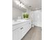 Well-lit bathroom with double vanity, shower and tub combo, toilet, and neutral tile at 821 Boulder Peak Ave, Erie, CO 80516