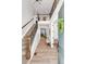 Inviting entryway with hardwood floors, a staircase with iron railings, and a view to other rooms at 821 Boulder Peak Ave, Erie, CO 80516