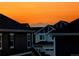 Distant mountain views at sunset visible above nearby rooftops at 821 Boulder Peak Ave, Erie, CO 80516