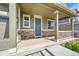 Inviting front porch with stone accents, a teal door with wreath, and space for seating at 821 Boulder Peak Ave, Erie, CO 80516