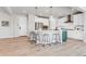 Spacious kitchen features an island with seating, stainless appliances, and stylish pendant lighting at 821 Boulder Peak Ave, Erie, CO 80516