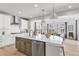 Bright kitchen with stainless steel appliances, an island, and seamless access to the dining area at 821 Boulder Peak Ave, Erie, CO 80516