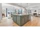Expansive kitchen island with plenty of storage and seating, flowing into dining and living areas at 821 Boulder Peak Ave, Erie, CO 80516
