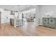 Bright, modern kitchen with white cabinets, island seating, and an open layout to the dining area at 821 Boulder Peak Ave, Erie, CO 80516