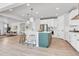 Open kitchen design with an island, pendant lights, stainless appliances, and hardwood flooring at 821 Boulder Peak Ave, Erie, CO 80516