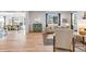 Open-concept living room with hardwood floors, modern furniture, and plenty of natural light at 821 Boulder Peak Ave, Erie, CO 80516