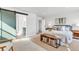 Spacious main bedroom featuring modern décor, a barn door to the bathroom, and ample natural light at 821 Boulder Peak Ave, Erie, CO 80516
