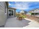 Patio with outdoor seating, perfect for entertaining, complemented by a stone retaining wall and green lawn at 821 Boulder Peak Ave, Erie, CO 80516