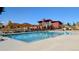 Beautiful community pool with outdoor furniture and shade structures at 821 Boulder Peak Ave, Erie, CO 80516