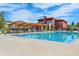 Community pool and clubhouse with ample seating and a pergola, perfect for relaxation and recreation at 821 Boulder Peak Ave, Erie, CO 80516