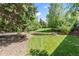 Lush backyard featuring a grass lawn, mature trees and landscape at 2520 Eldridge Cir, Golden, CO 80401