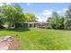 Large, landscaped backyard with a patio and lush lawn at 2520 Eldridge Cir, Golden, CO 80401