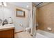 Bright bathroom with tiled shower and floors, and a classic vanity at 2520 Eldridge Cir, Golden, CO 80401